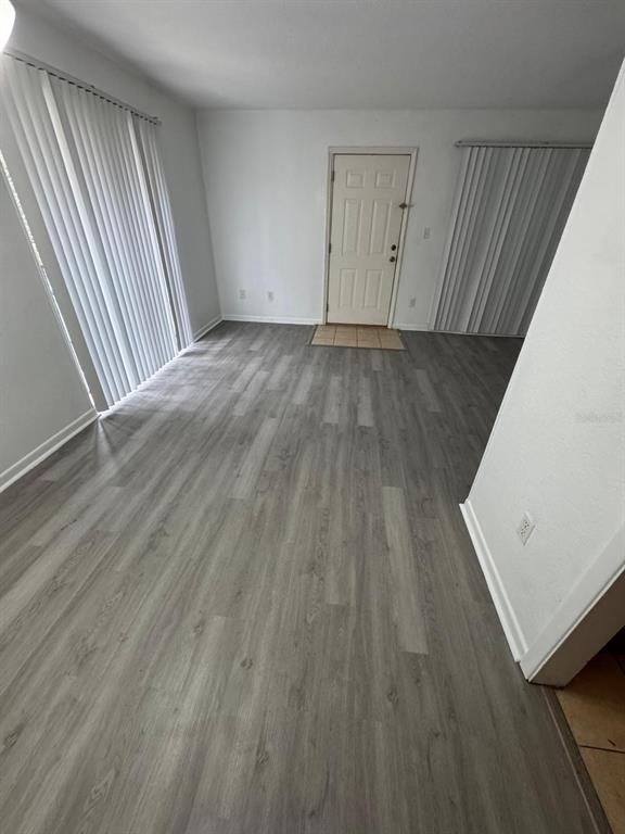 507 Northwest 39th Road, Unit 220 Gainesville, FL 32607 - Photo 17 of 21 wooden floor in a hall with an entryway