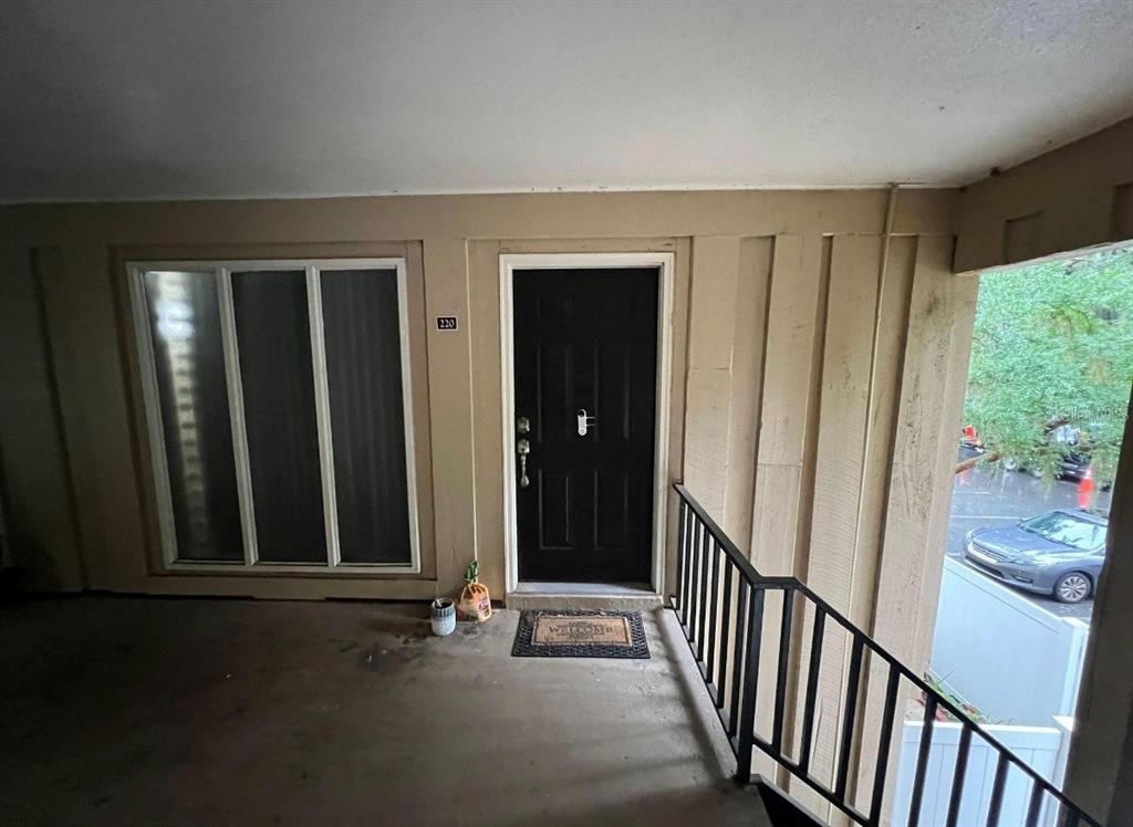 507 Northwest 39th Road, Unit 220 Gainesville, FL 32607 - Photo 3 of 21 a view of a hallway with wooden floor and stairs