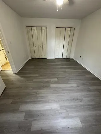 a view of a hallway view with wooden floor and staircase
