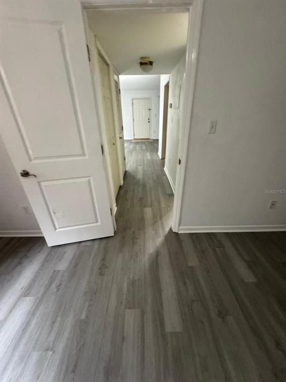 507 Northwest 39th Road, Unit 220 Gainesville, FL 32607 - Photo 8 of 21 a view of a hallway view with wooden floor and staircase