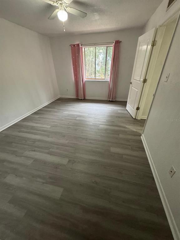 507 Northwest 39th Road, Unit 220 Gainesville, FL 32607 - Photo 9 of 21 wooden floor in an empty room with a window