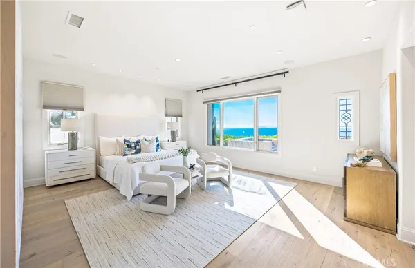 a spacious bedroom with a bed and a large window