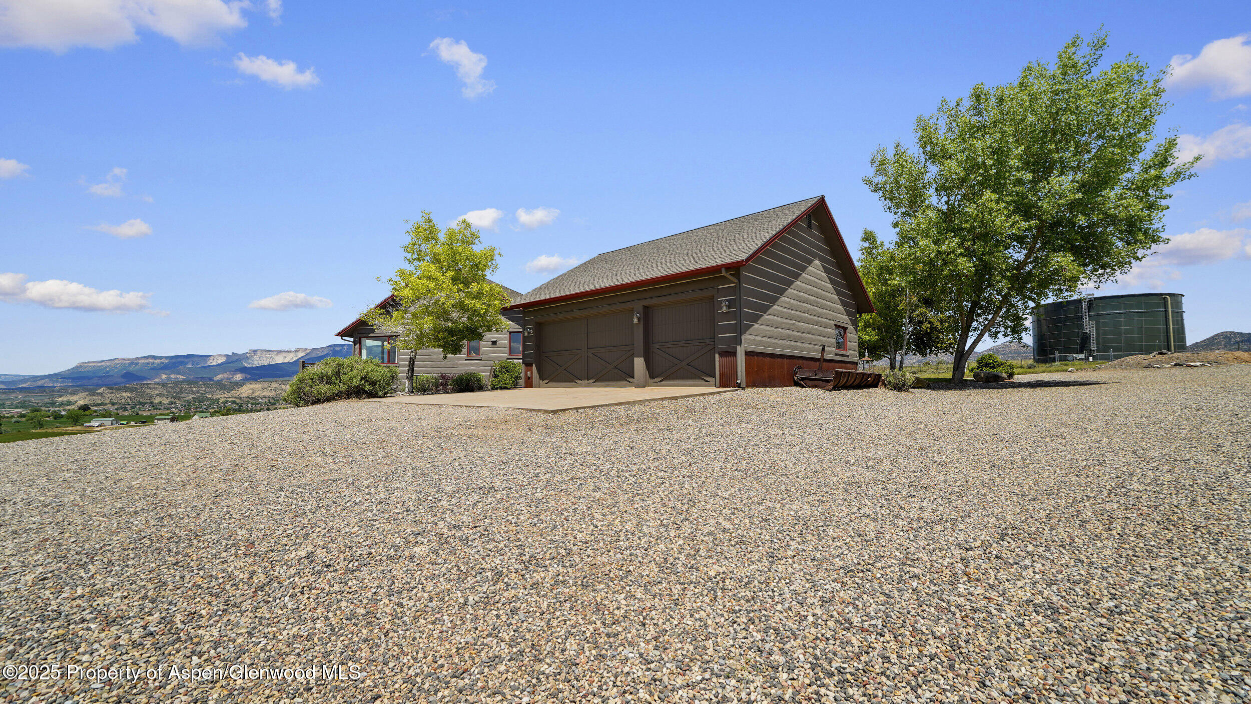 164 Booms Place Rifle, CO 81650 - Photo 17 of 33 a view of a house with a yard and garage