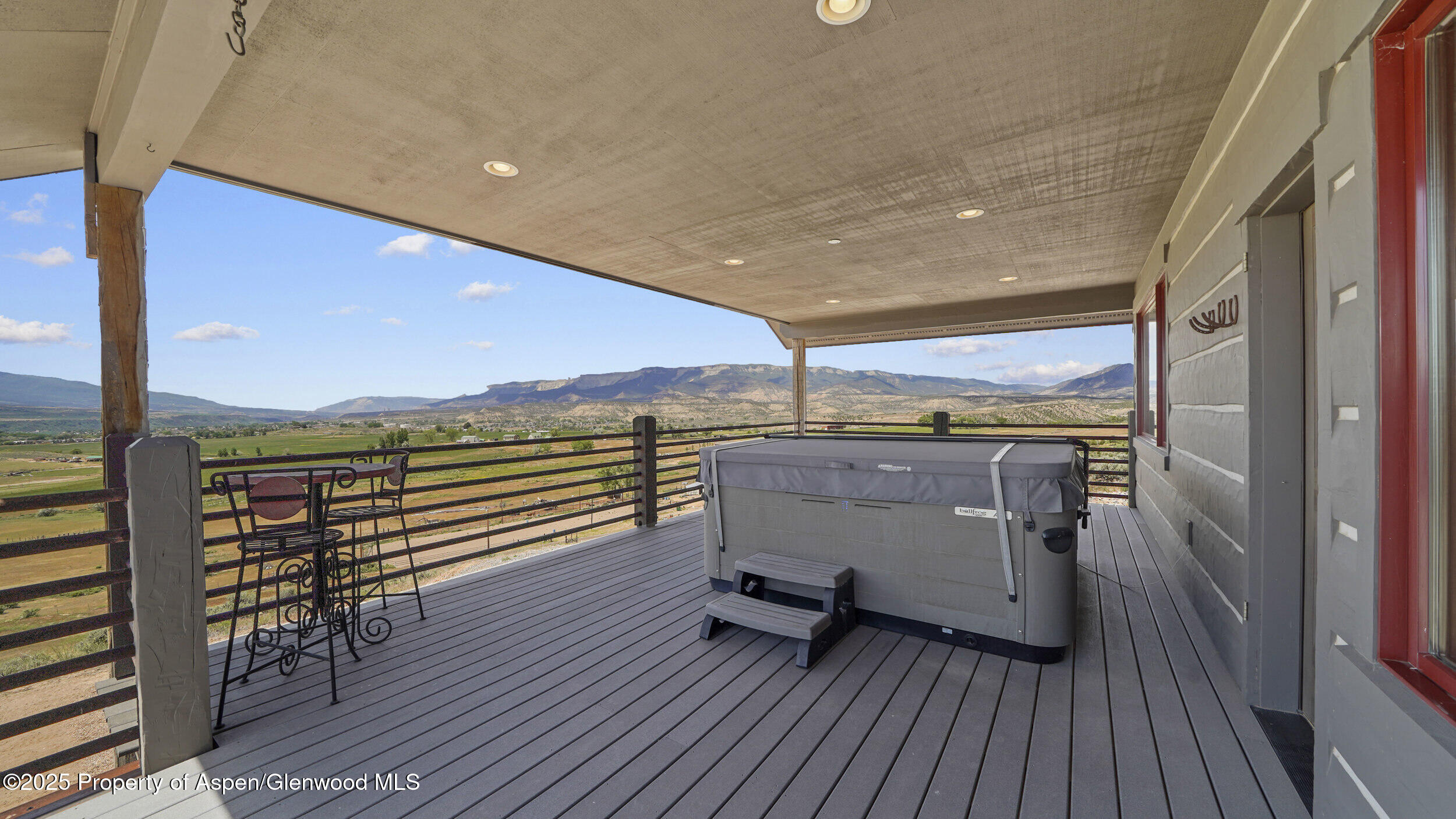 164 Booms Place Rifle, CO 81650 - Photo 22 of 33 a view of a balcony with furniture and wooden floor