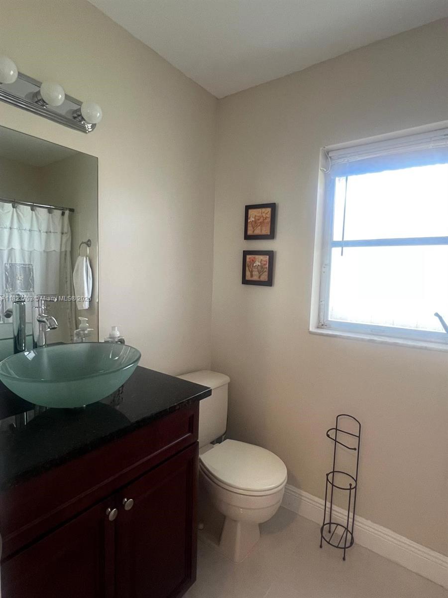 18906 Schooner Drive Boca Raton, FL 33496 - Photo 12 of 15 a bathroom with a toilet a sink and mirror