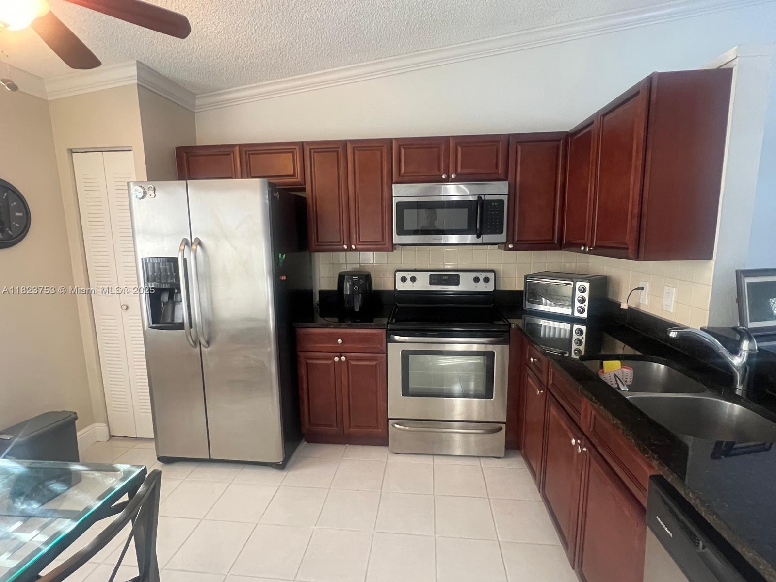 18906 Schooner Drive Boca Raton, FL 33496 - Photo 6 of 15 a kitchen with a refrigerator sink and microwave