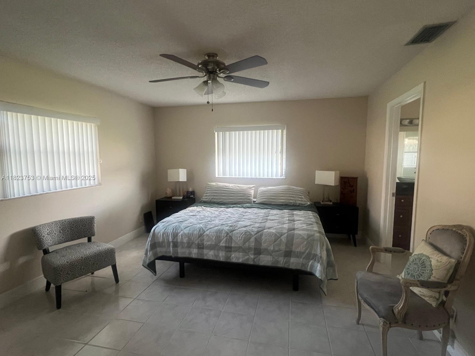 18906 Schooner Drive Boca Raton, FL 33496 - Photo 8 of 15 a bedroom with a bed chair and window