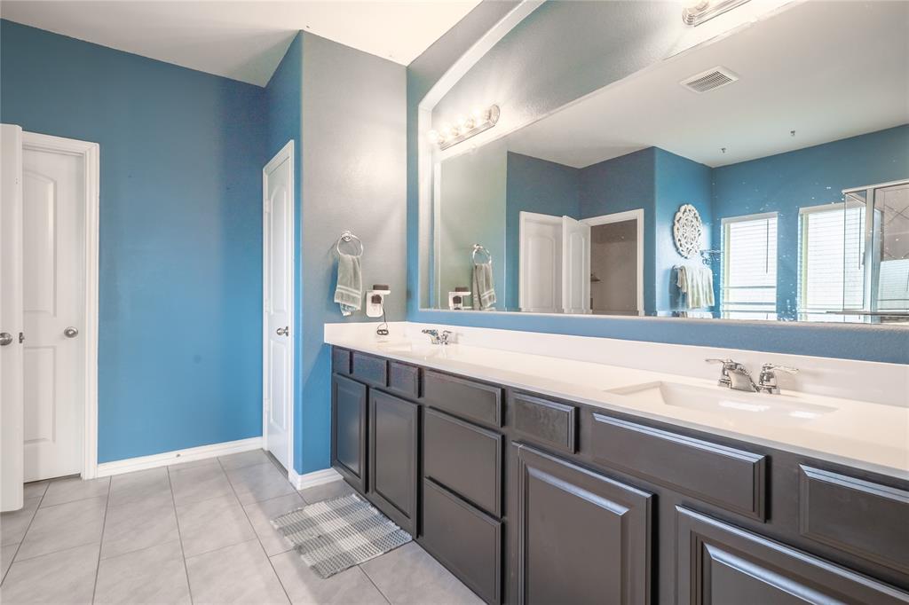 4542 Kipling Avenue Aubrey, TX 76227 - Photo 16 of 34 a bathroom with a sink and a mirror