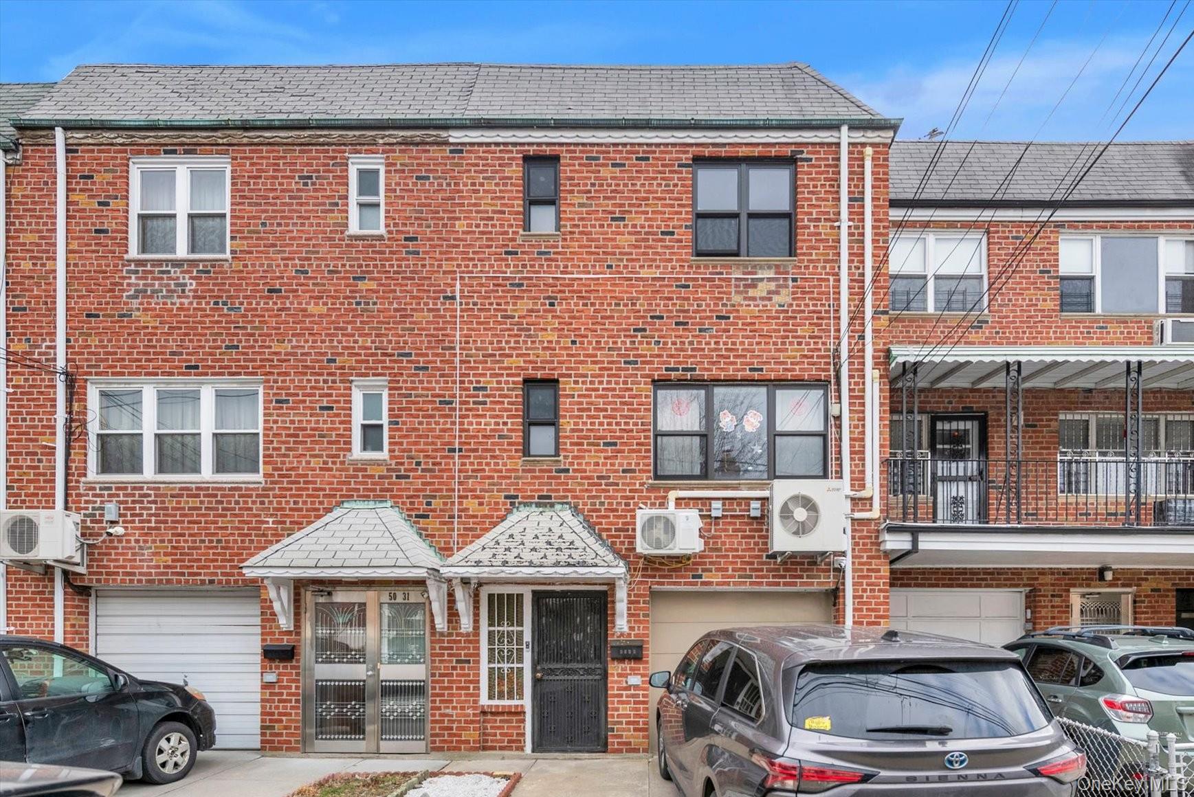 50-33 68th Street Queens, NY 11377 - Photo 1 of 17 a front view of a building with parking space