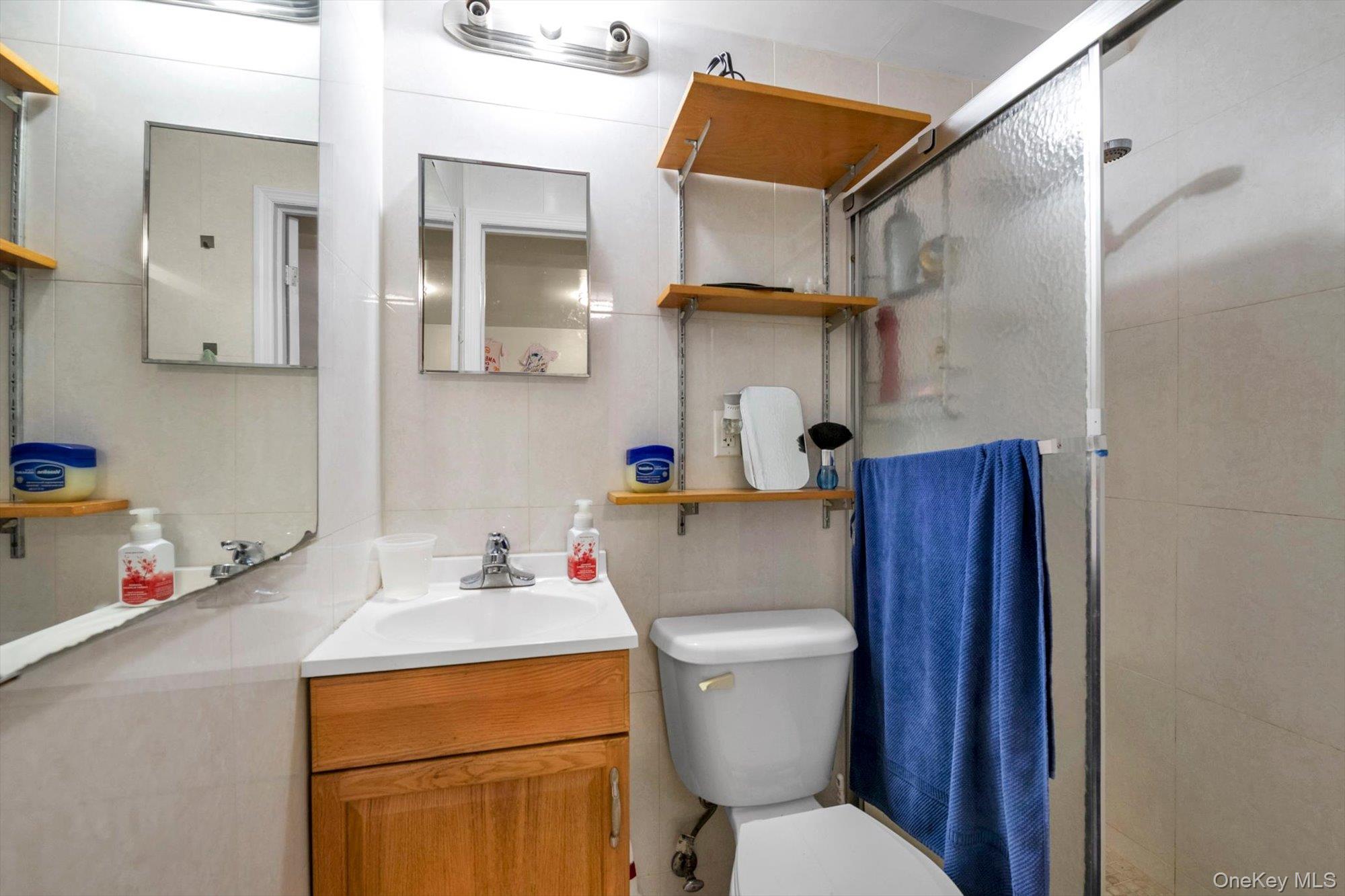 50-33 68th Street Queens, NY 11377 - Photo 14 of 17 a bathroom with a sink toilet and vanity