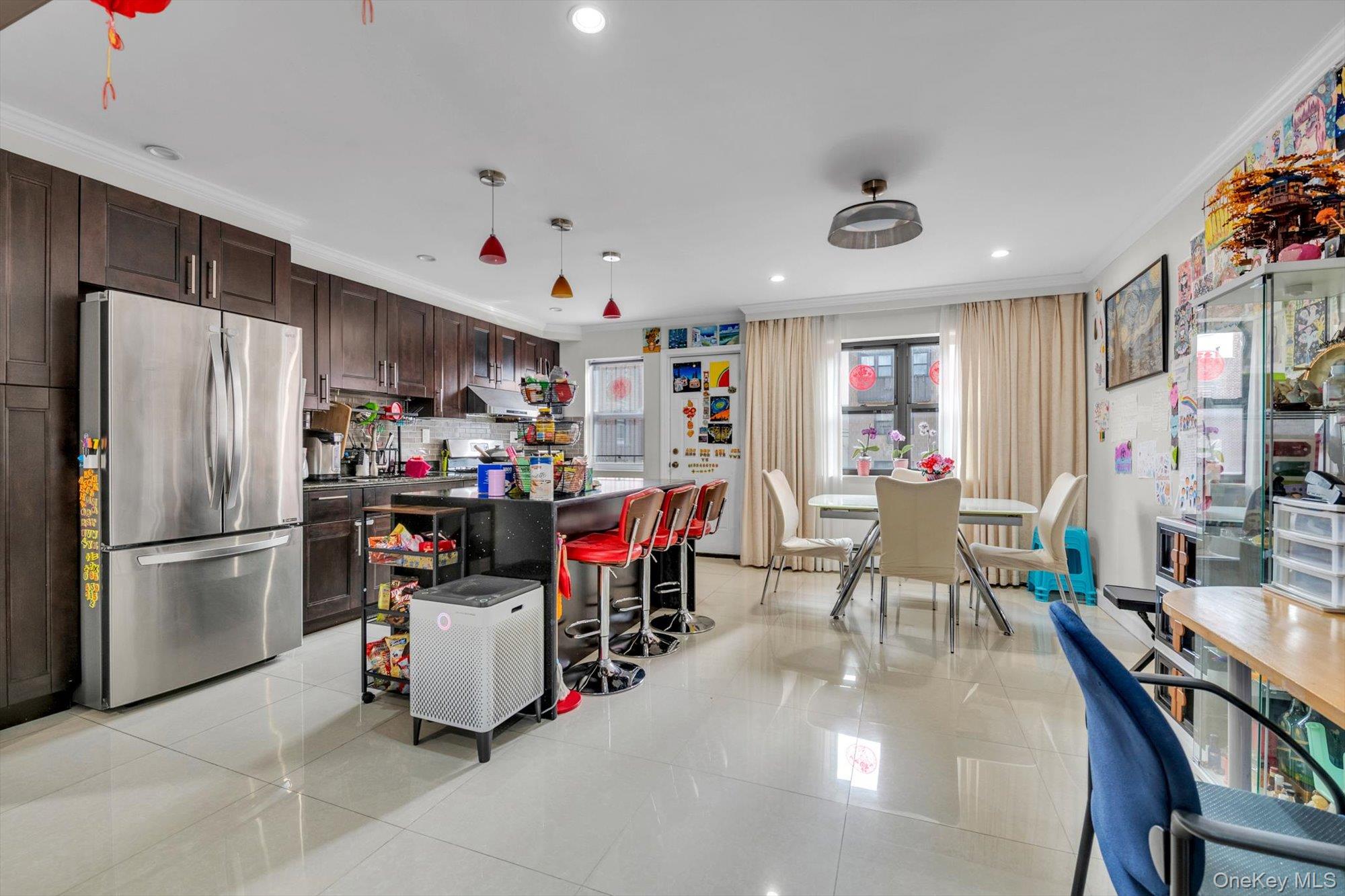 50-33 68th Street Queens, NY 11377 - Photo 2 of 17 a kitchen with stainless steel appliances kitchen island granite countertop a refrigerator a stove and a dining table with wooden floor