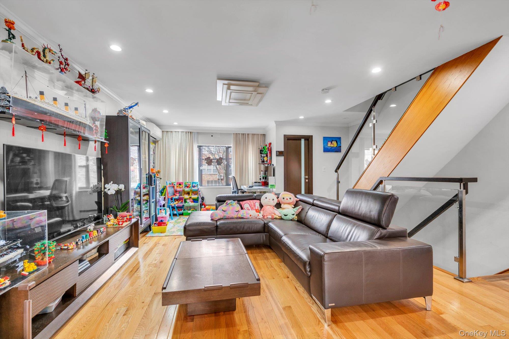 50-33 68th Street Queens, NY 11377 - Photo 4 of 17 a living room with furniture and a flat screen tv
