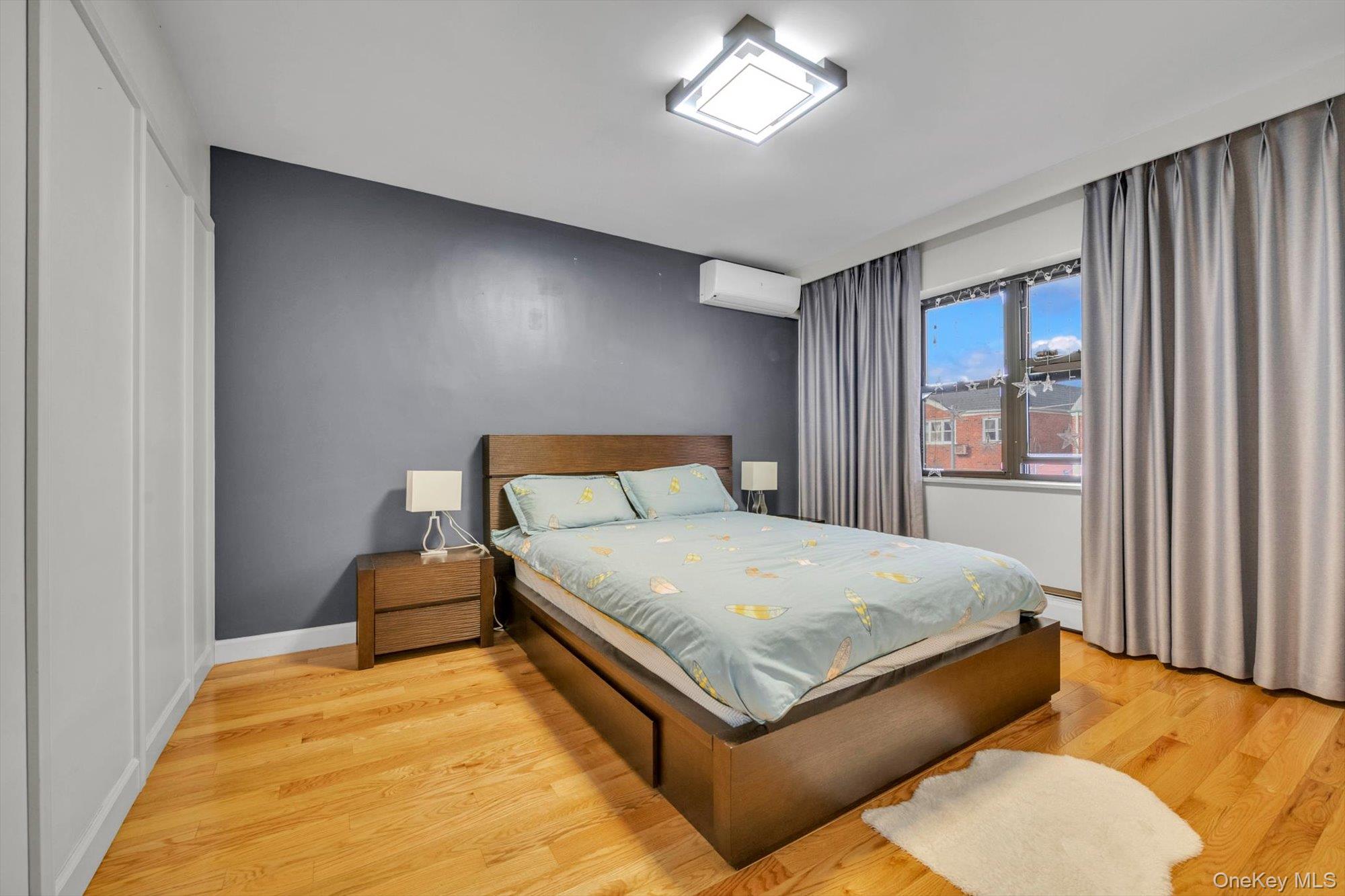 50-33 68th Street Queens, NY 11377 - Photo 7 of 17 a bed sitting in a spacious bedroom next to a window