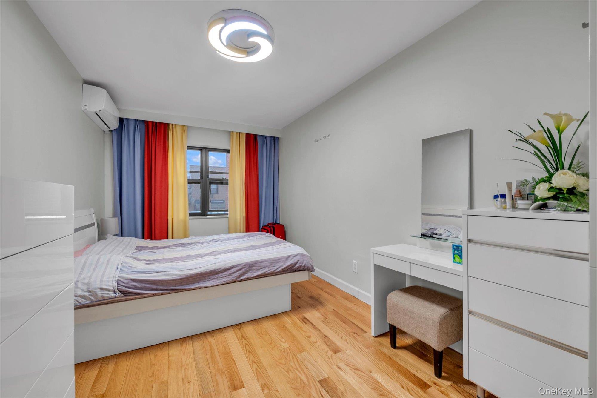 50-33 68th Street Queens, NY 11377 - Photo 8 of 17 a bedroom with a bed and a dresser