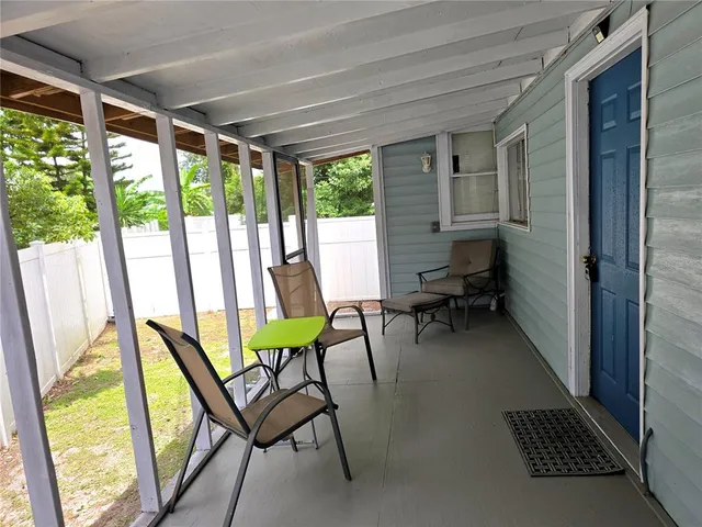 a view of a room with furniture and a window