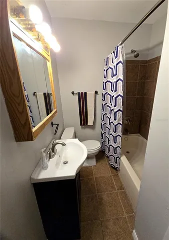 a bathroom with a sink and mirror with toilet