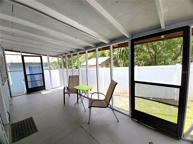 a view of a room with furniture and floor to ceiling windows
