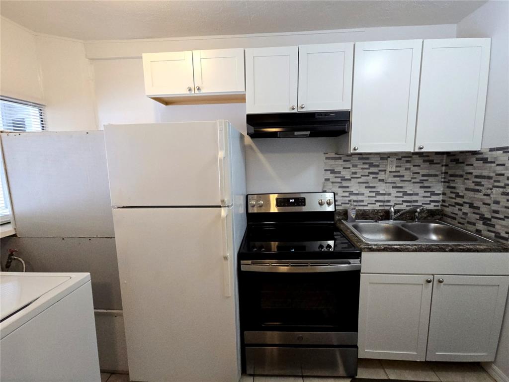 1839 Salem Road, Unit B Lakeland, FL 33803 - Photo 2 of 24 a kitchen with a sink and white cabinets