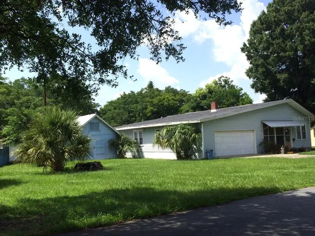 a front view of house with yard and green space