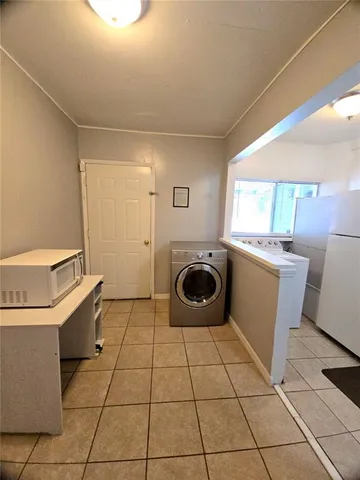 a kitchen with a stove top oven and cabinets