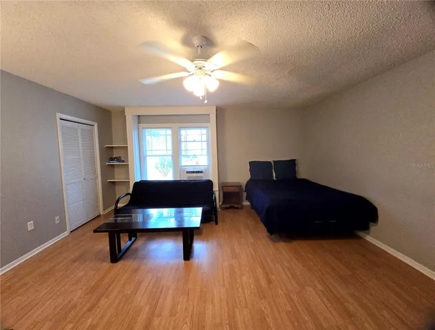 a living room with a bed furniture and a window