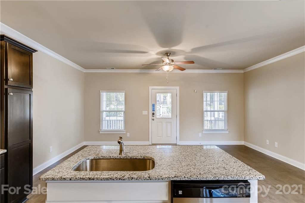 12208 Huntersville-Concord Road Huntersville, NC 28078 - Photo 11 of 33 a kitchen with a sink a refrigerator and chandelier