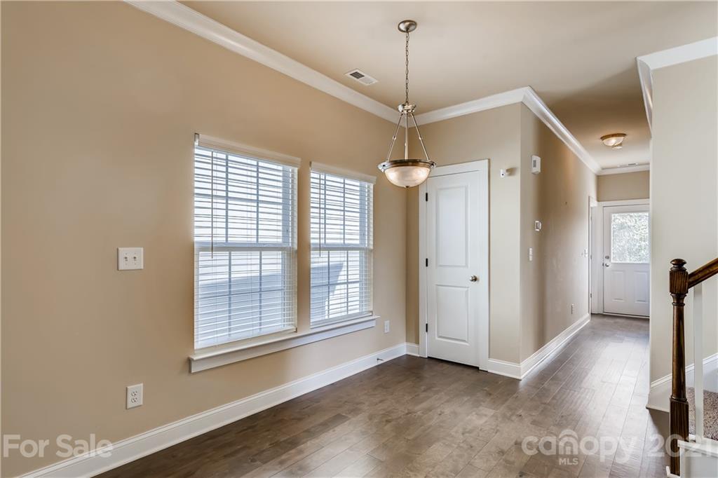 12208 Huntersville-Concord Road Huntersville, NC 28078 - Photo 12 of 33 a view of empty room with wooden floor and window