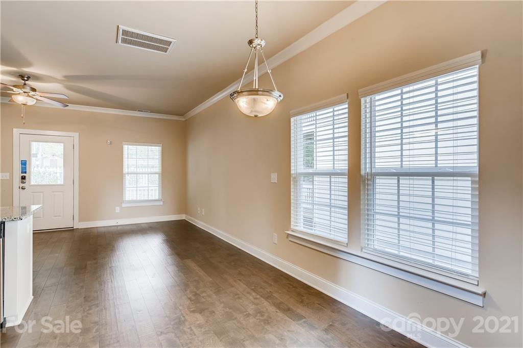 12208 Huntersville-Concord Road Huntersville, NC 28078 - Photo 13 of 33 a view of an empty room with wooden floor and a window