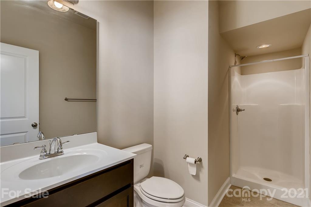 12208 Huntersville-Concord Road Huntersville, NC 28078 - Photo 16 of 33 a bathroom with a sink toilet vanity and shower