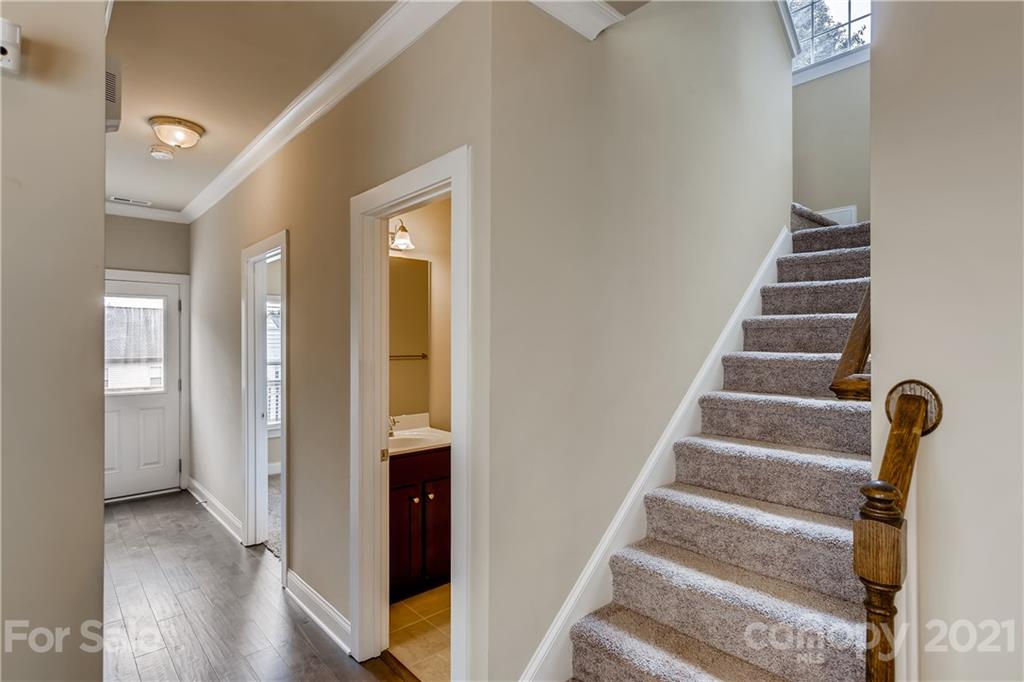 12208 Huntersville-Concord Road Huntersville, NC 28078 - Photo 17 of 33 a view of an entryway with wooden floor and staircase