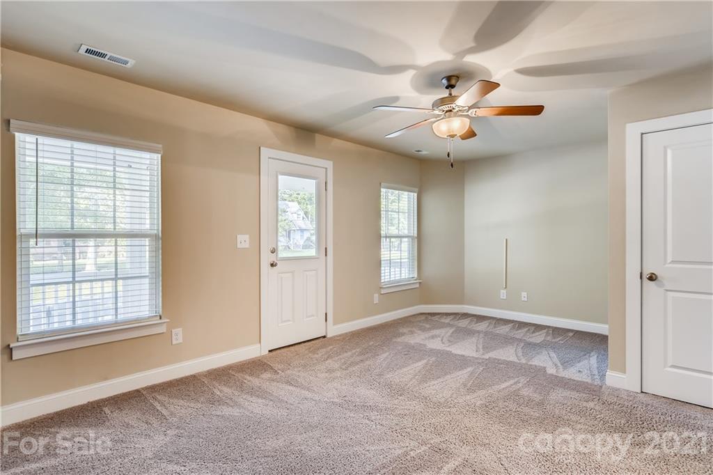 12208 Huntersville-Concord Road Huntersville, NC 28078 - Photo 18 of 33 a view of an empty room with window and chandelier fan
