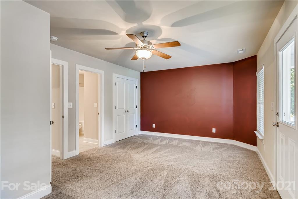 12208 Huntersville-Concord Road Huntersville, NC 28078 - Photo 21 of 33 a view of an empty room with a ceiling fan