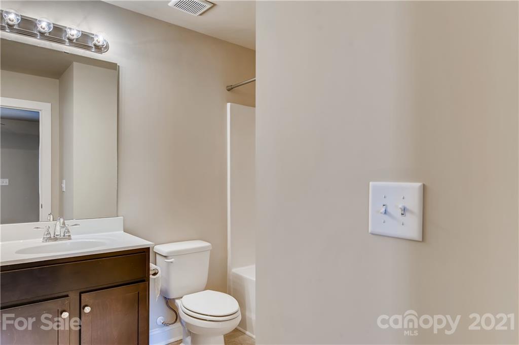 12208 Huntersville-Concord Road Huntersville, NC 28078 - Photo 22 of 33 a bathroom with a toilet a sink and mirror