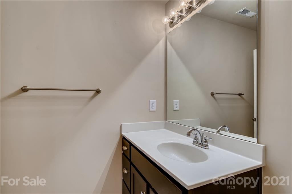 12208 Huntersville-Concord Road Huntersville, NC 28078 - Photo 23 of 33 a bathroom with a sink and a mirror