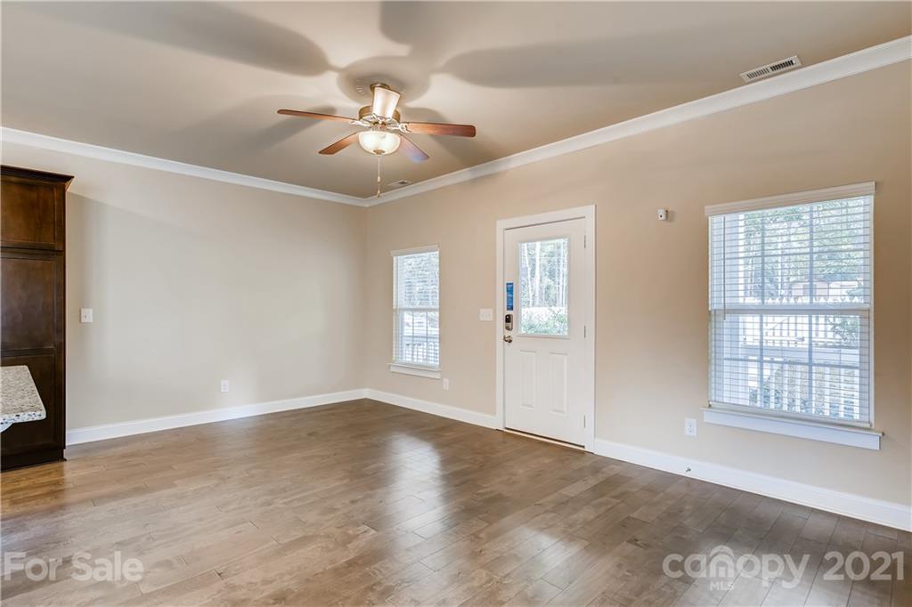 12208 Huntersville-Concord Road Huntersville, NC 28078 - Photo 5 of 33 a view of an empty room with a window and wooden floor