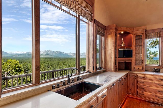 a kitchen with a large window and a sink