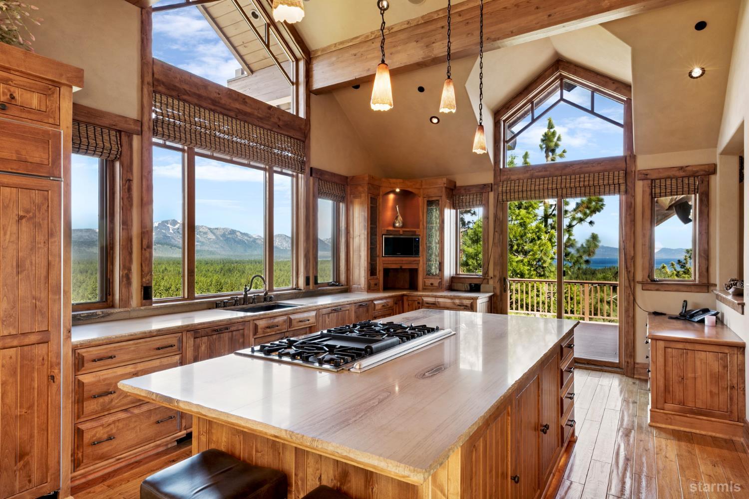 3567 Saddle Road South Lake Tahoe, CA 96150 - Photo 15 of 39 a view of a dining room with furniture large windows and wooden floor