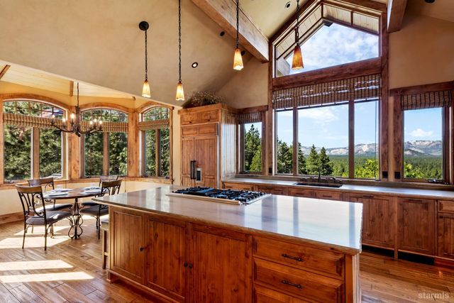 a view of a kitchen with granite countertop a large window and a counter space