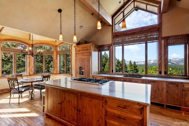 a view of a kitchen with granite countertop a large window and a counter space