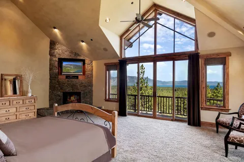 a bedroom with a bed and a fireplace