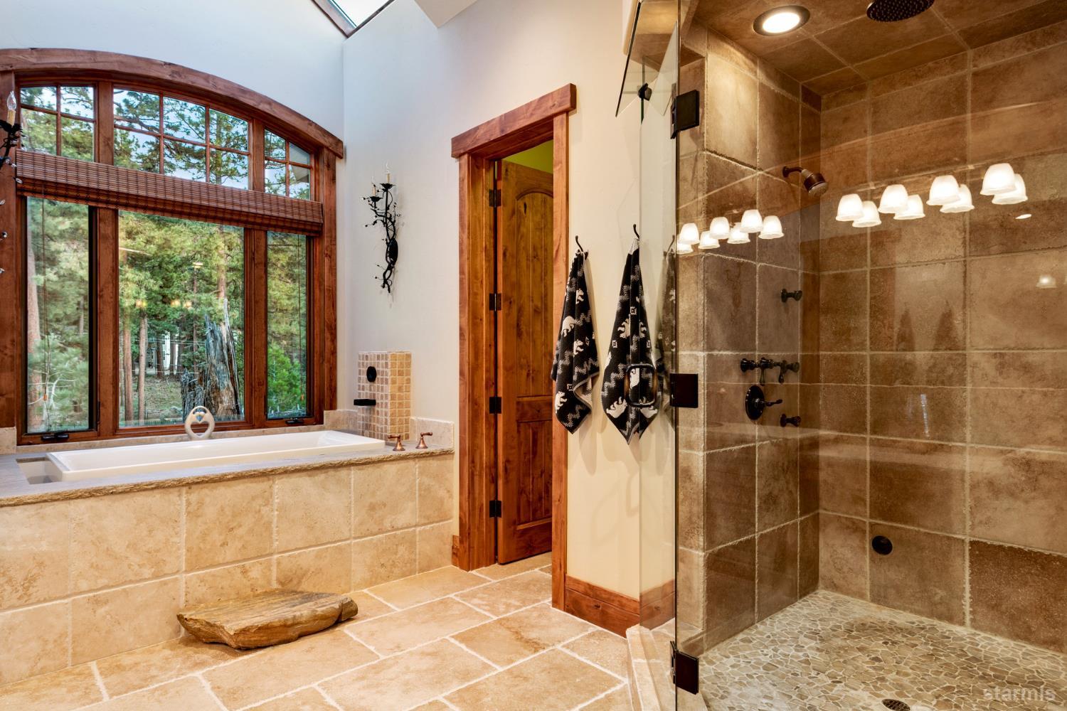3567 Saddle Road South Lake Tahoe, CA 96150 - Photo 27 of 39 a bathroom with a glass shower door and a window