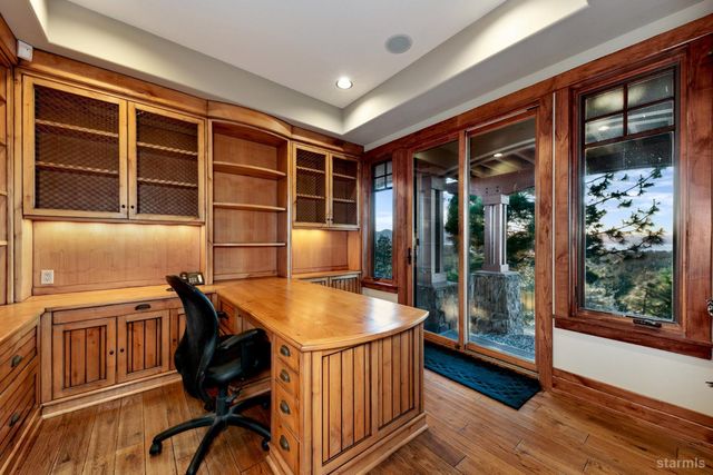 a dining room with a wooden table and chairs