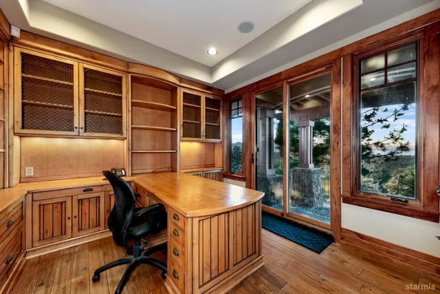 a dining room with a wooden table and chairs