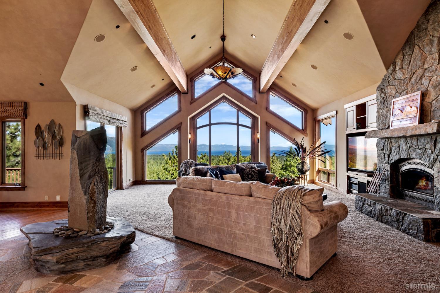 3567 Saddle Road South Lake Tahoe, CA 96150 - Photo 8 of 39 a living room with furniture a fireplace and a floor to ceiling window