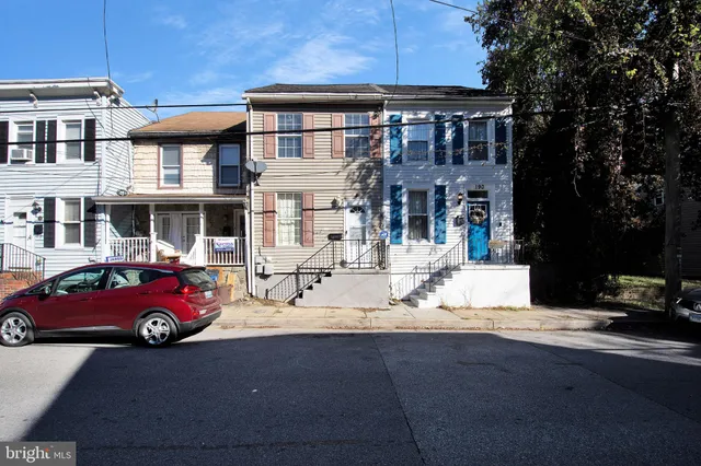 a front view of a residential apartment building with a yard