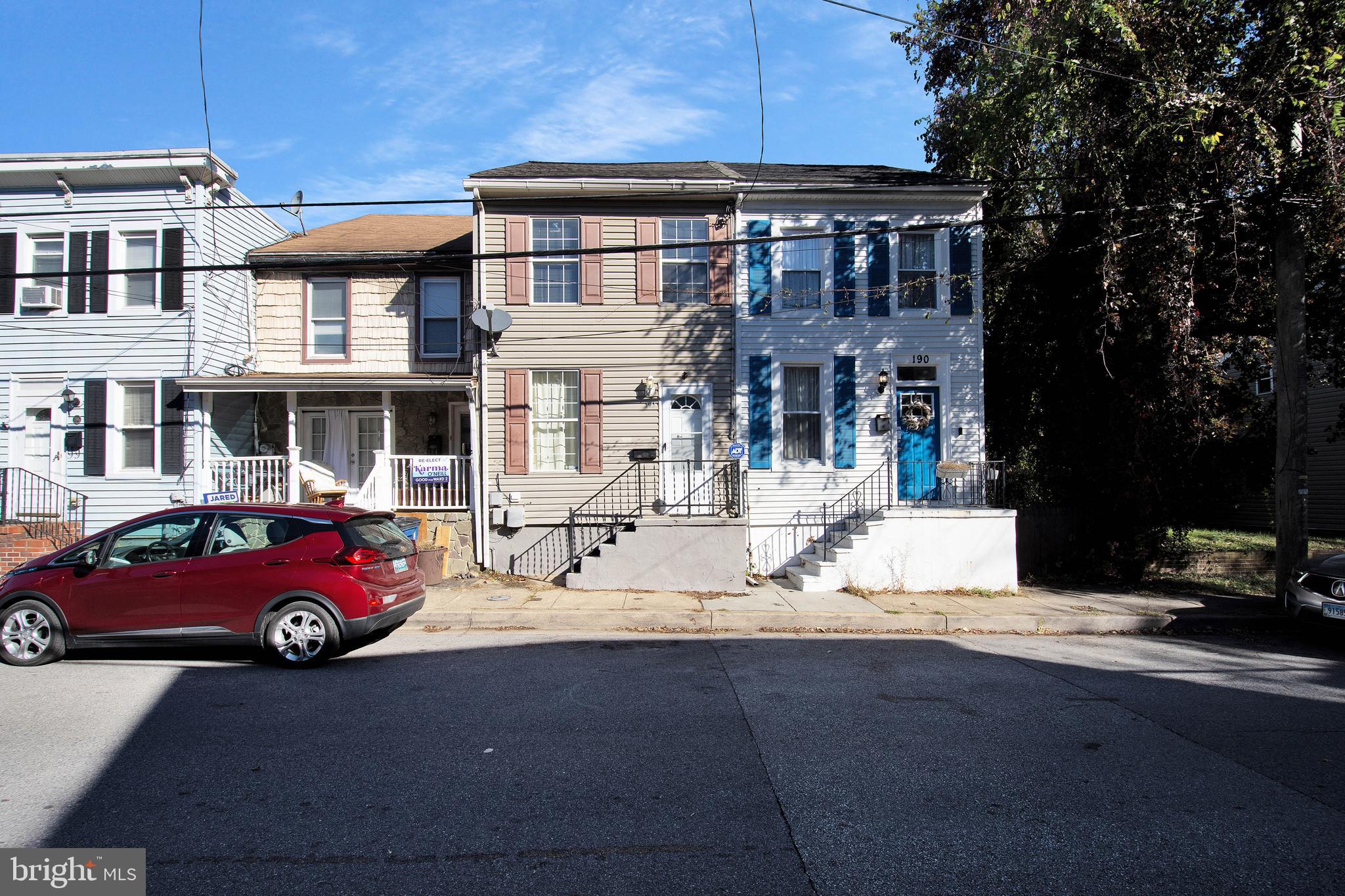 a front view of a residential apartment building with a yard
