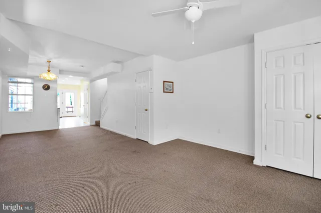 a view of a livingroom with a ceiling fan and window