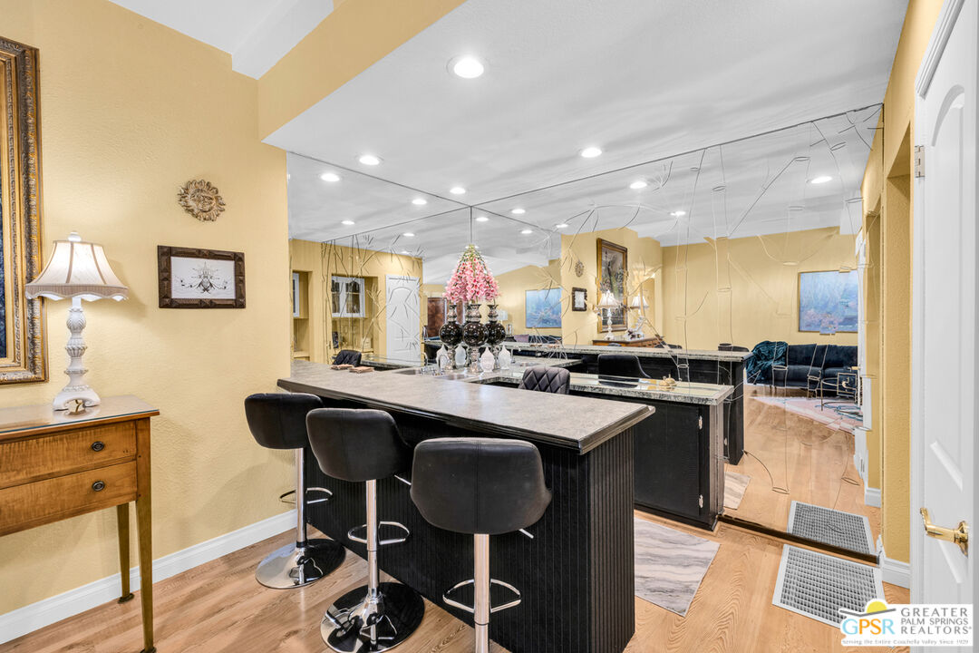 10 International Boulevard Rancho Mirage, CA 92270 - Photo 12 of 36 a kitchen with counter space dining table and chairs