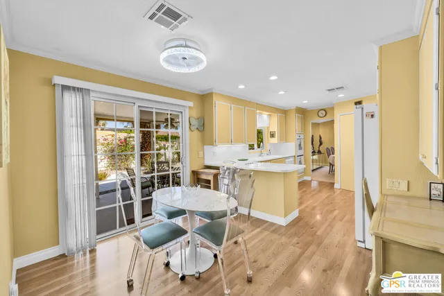 a living room with a table chairs and a dining table