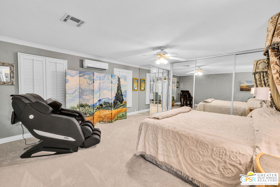 10 International Boulevard Rancho Mirage, CA 92270 - Photo 19 of 36 a bedroom with a bed couch and a window